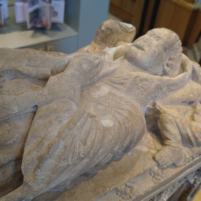 A details of a figure carved in stone on a medieval tomb in Beverley Minster.