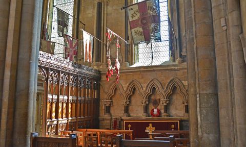 A view of the Regimental Chapel in Beverley Minster with its hanging military standards.