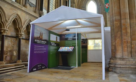 The 'Sanctuary tent' in the North Transept of Beverley Minster has a wooden frame and white canvas.