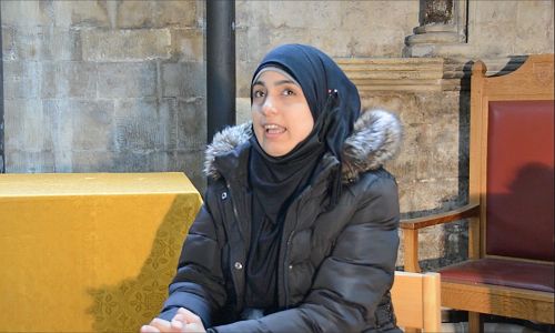 A Syrian woman in a dark headscarf speaks about her experiences as an asylum seeker in the UK.